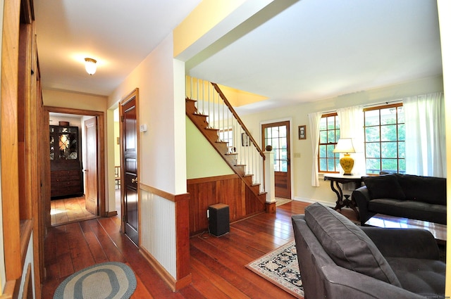 living room featuring wooden walls and dark hardwood / wood-style flooring