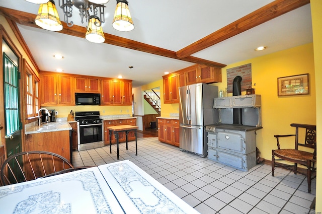 kitchen with hanging light fixtures, stainless steel fridge, light tile patterned floors, beamed ceiling, and range