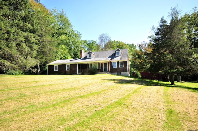 cape cod home featuring covered porch and a front yard