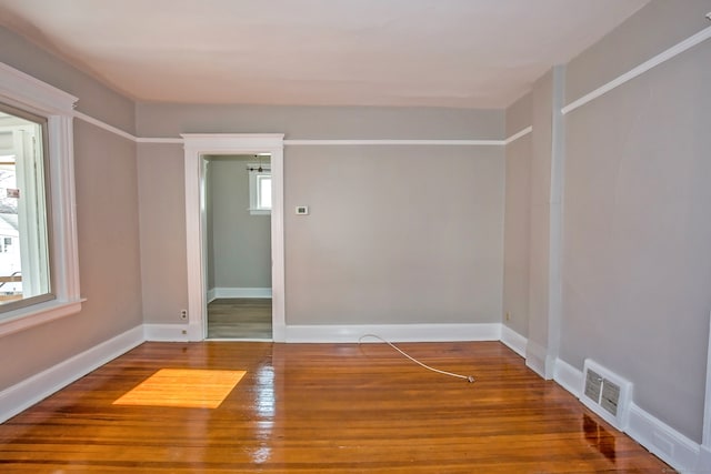 empty room featuring hardwood / wood-style flooring and a wealth of natural light