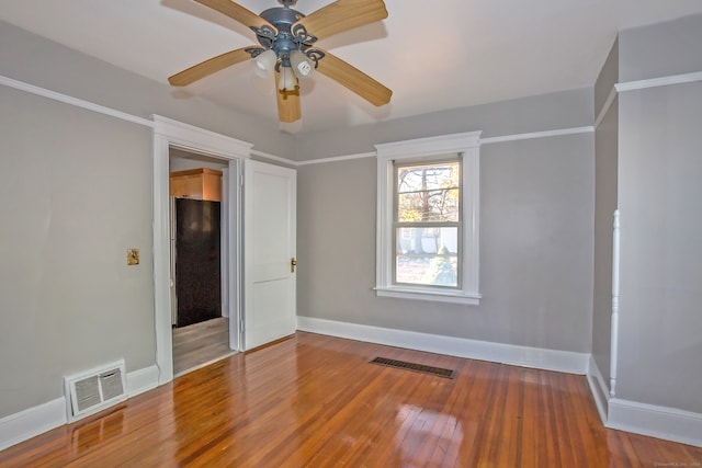 spare room with ceiling fan and hardwood / wood-style flooring