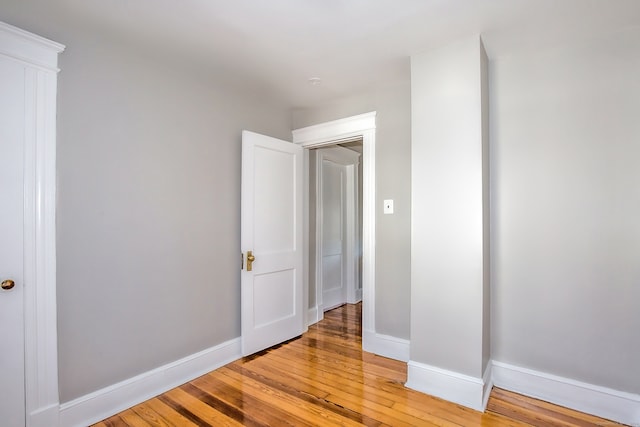 spare room featuring wood-type flooring