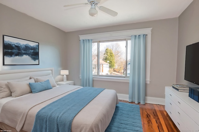 bedroom with ceiling fan and dark wood-type flooring