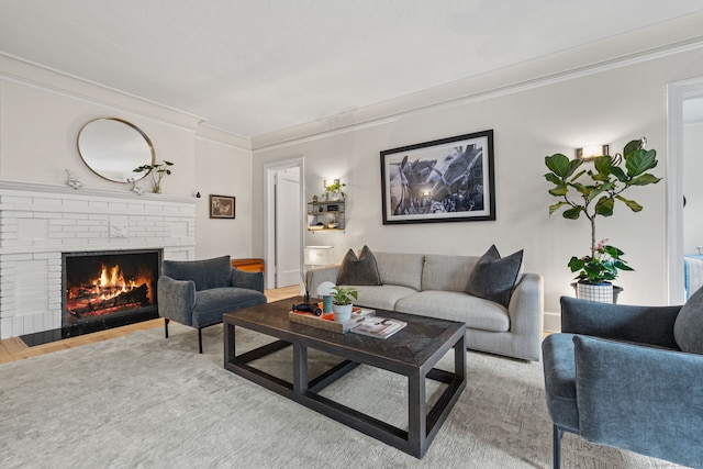 living room featuring crown molding, wood-type flooring, and a brick fireplace