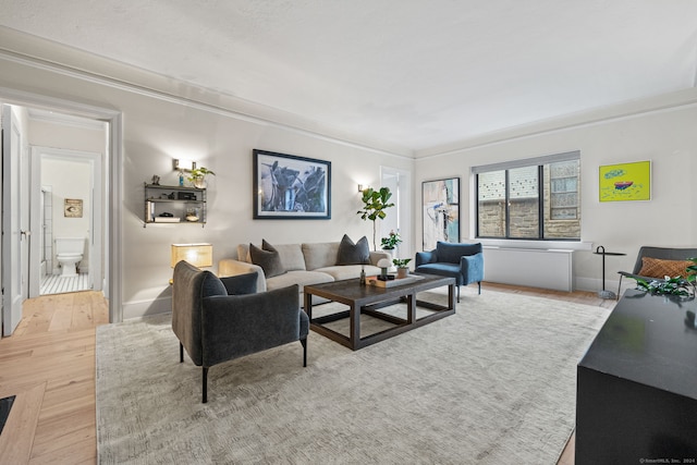 living room with hardwood / wood-style floors and crown molding