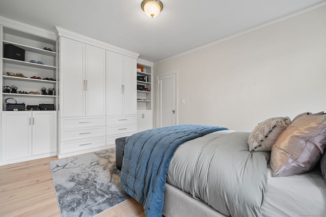 bedroom with light hardwood / wood-style floors and ornamental molding