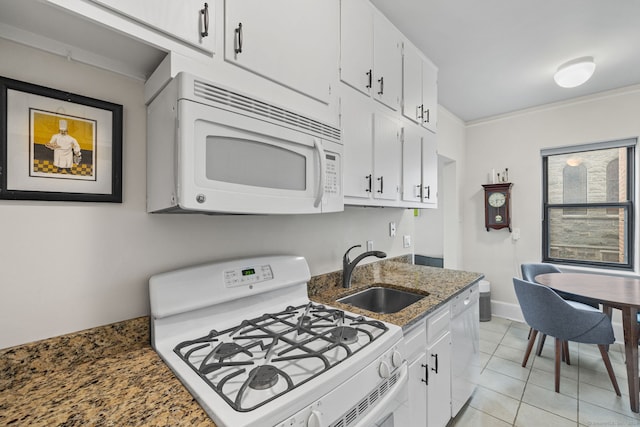 kitchen with white cabinets, white appliances, dark stone counters, and sink