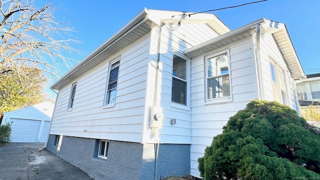 view of side of property featuring a garage and an outdoor structure