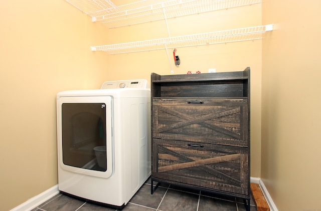 laundry area with washer / clothes dryer and dark tile patterned flooring