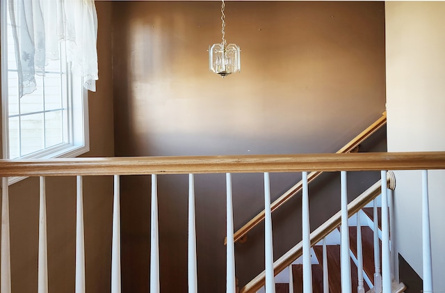 stairway featuring an inviting chandelier