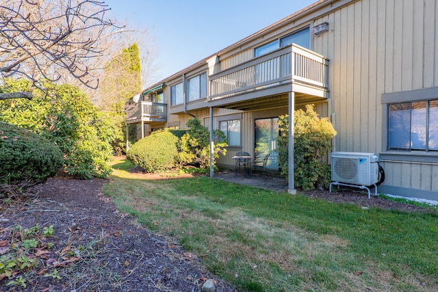 view of yard featuring ac unit and a balcony