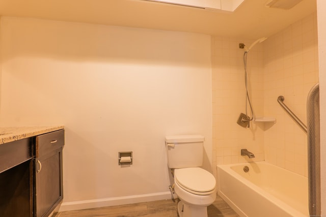 full bathroom with baseboards, toilet, shower / bathing tub combination, wood finished floors, and vanity