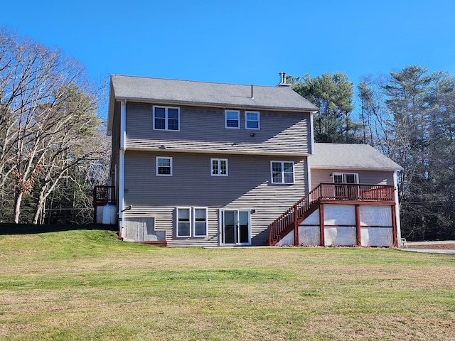 rear view of house with a yard and a deck