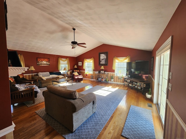 living room featuring hardwood / wood-style flooring, lofted ceiling, and ceiling fan