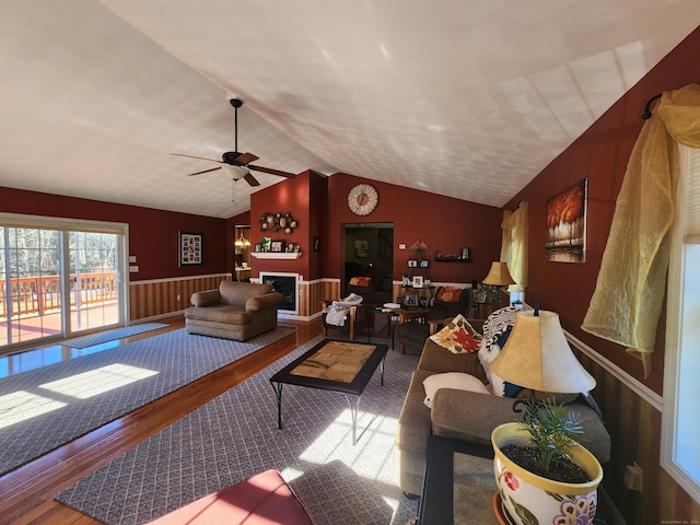 living room featuring hardwood / wood-style floors, vaulted ceiling, and ceiling fan