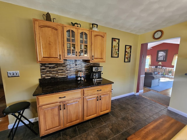 kitchen with tasteful backsplash and dark stone counters