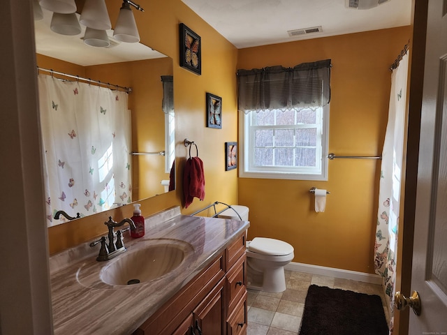 bathroom with vanity, tile patterned floors, and toilet