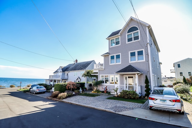 view of front of house with a water view