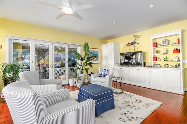 living room featuring light wood-type flooring and ceiling fan