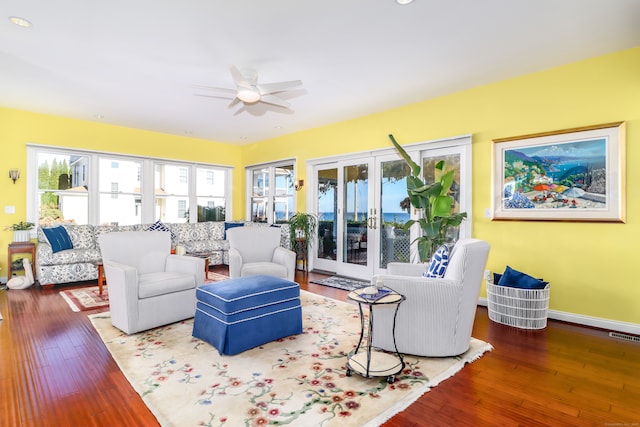 living room with hardwood / wood-style floors and ceiling fan