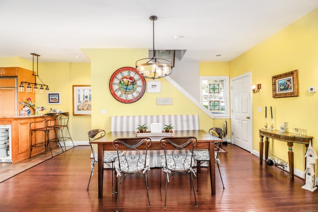 dining space with a notable chandelier, dark hardwood / wood-style flooring, and wine cooler