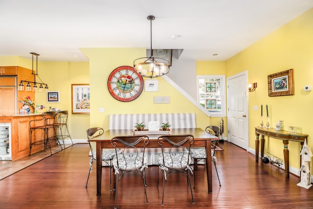 1 Dunbar Rd, Milford, CT 06460 - dining area with dark wood finished floors, baseboards, a chandelier, and wine cooler