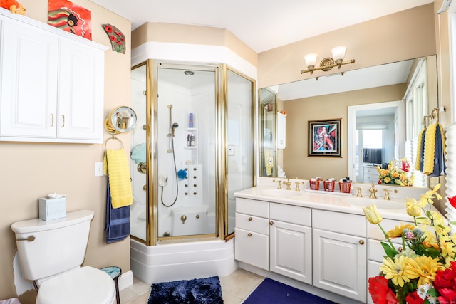 bathroom featuring tile patterned floors, vanity, toilet, and an enclosed shower