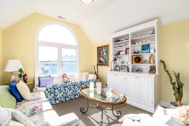 carpeted living room with vaulted ceiling