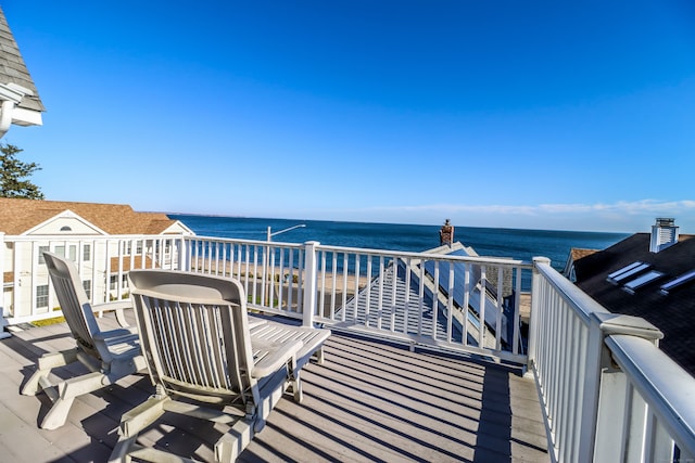 wooden deck featuring a water view