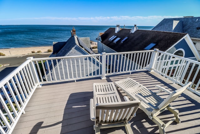 deck featuring a beach view and a water view