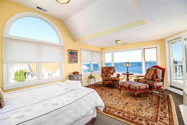 carpeted bedroom with a water view and lofted ceiling