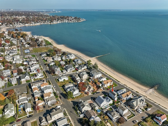 bird's eye view featuring a water view and a beach view