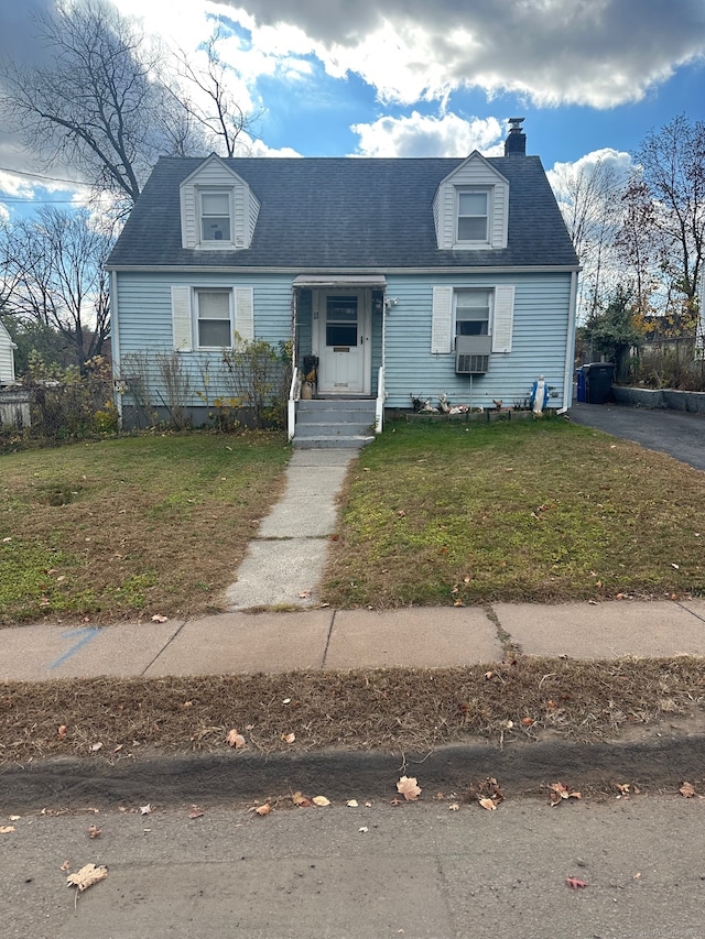 cape cod house featuring a front lawn