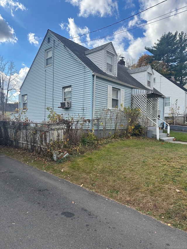 view of side of home with a yard and cooling unit