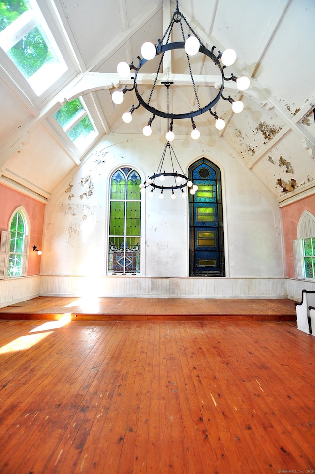 14 River Rd, Cornwall, CT 06796 - interior space featuring a chandelier, lofted ceiling, hardwood / wood-style floors, a wainscoted wall, and wood walls
