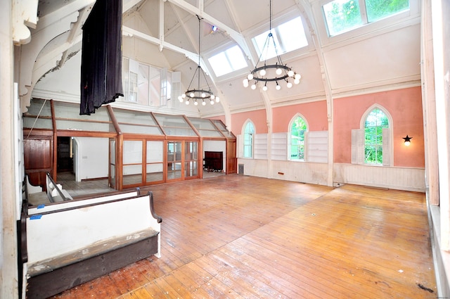 14 River Rd, Cornwall, CT 06796 - miscellaneous room with a chandelier, high vaulted ceiling, wainscoting, hardwood / wood-style flooring, and beam ceiling