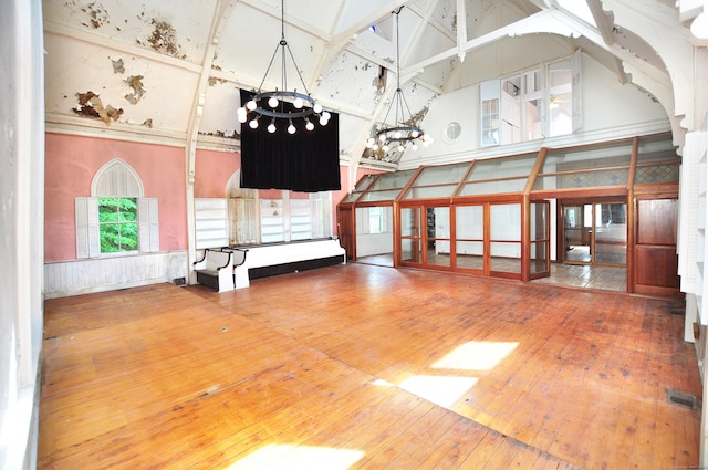 14 River Rd, Cornwall, CT 06796 - empty room featuring high vaulted ceiling, a chandelier, and hardwood / wood-style flooring