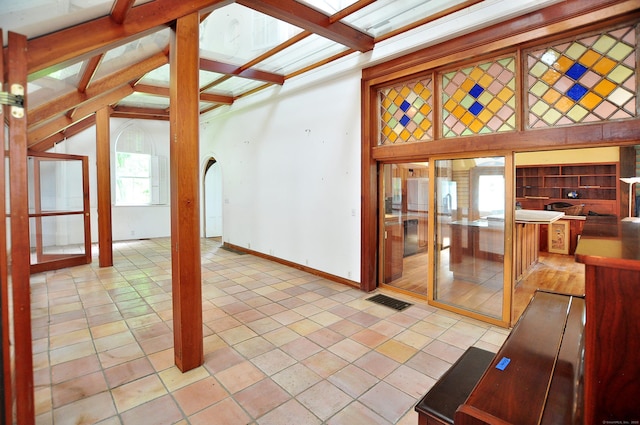 14 River Rd, Cornwall, CT 06796 - unfurnished living room with light tile patterned floors and vaulted ceiling