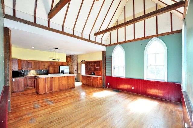 14 River Rd, Cornwall, CT 06796 - kitchen featuring stainless steel fridge, high vaulted ceiling, brown cabinetry, black microwave, and light wood finished floors