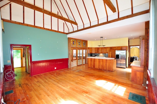 14 River Rd, Cornwall, CT 06796 - unfurnished living room with a high ceiling, light wood-type flooring, and a wainscoted wall