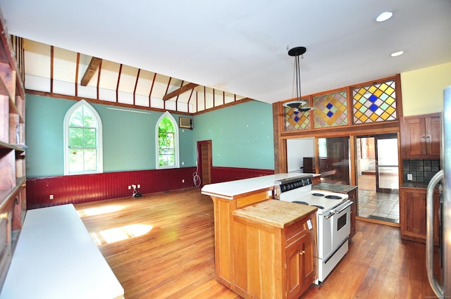 14 River Rd, Cornwall, CT 06796 - kitchen featuring white range with electric stovetop, a wainscoted wall, light wood-type flooring, light countertops, and a center island
