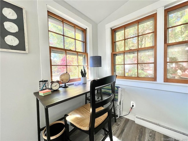 office area with a healthy amount of sunlight, vaulted ceiling, and a baseboard heating unit