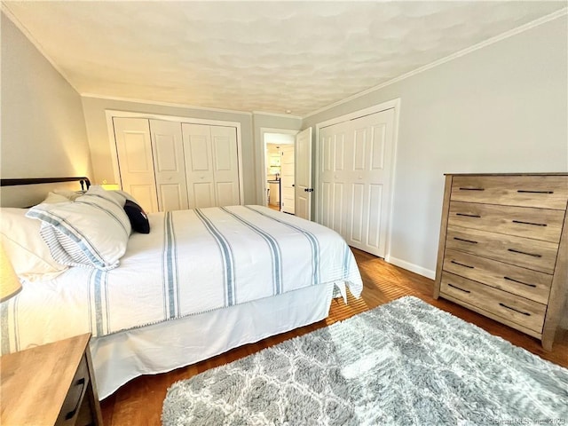 bedroom with crown molding and dark wood-type flooring