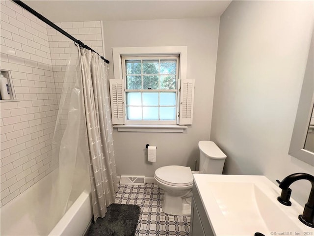 full bathroom with vanity, shower / bath combo, and toilet