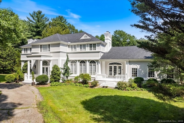 view of front of house with french doors and a front lawn