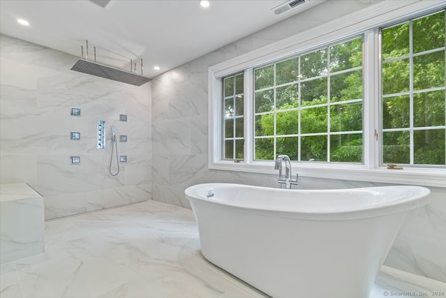 bathroom with plus walk in shower and tile walls