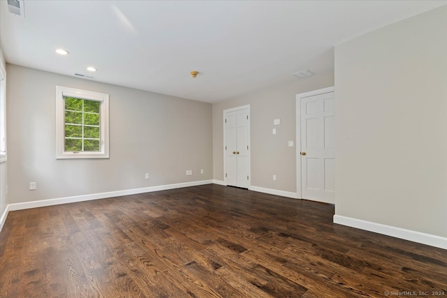 spare room with dark hardwood / wood-style floors