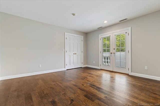 spare room featuring french doors and dark hardwood / wood-style floors