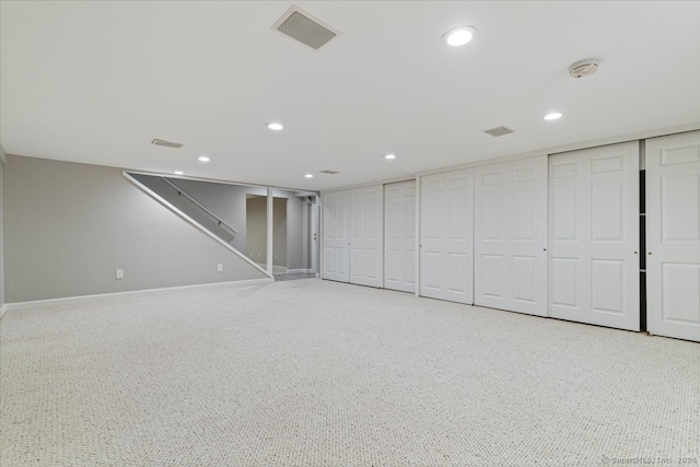 basement featuring light colored carpet