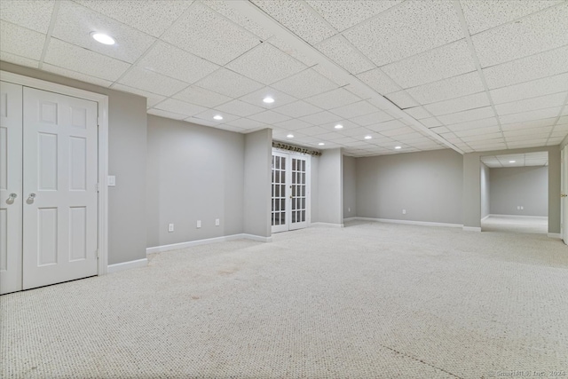 basement featuring carpet flooring and a drop ceiling